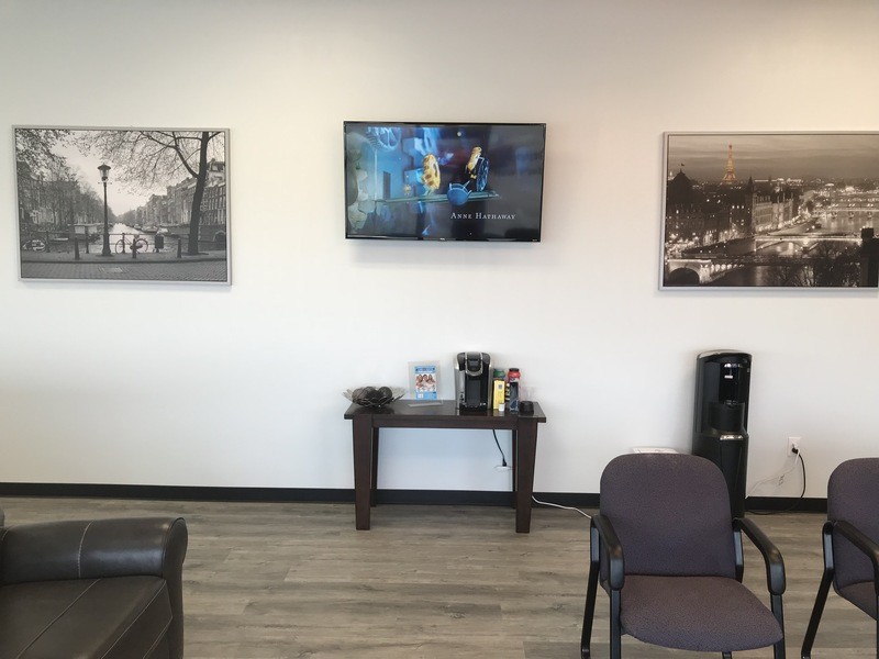 Care Dental TX television and portraits on the wall
